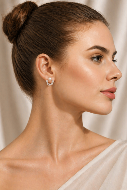model wearing pearl halo earrings in soft lighting