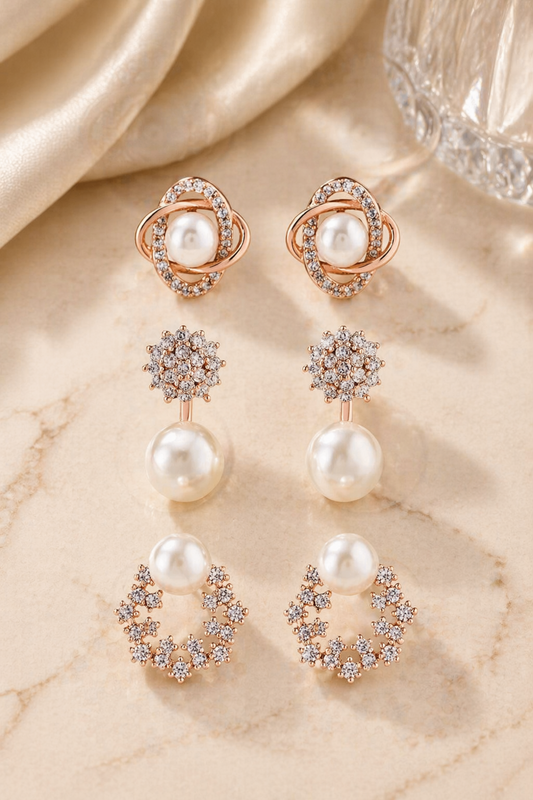 rose gold pearl stud earrings set on marble background