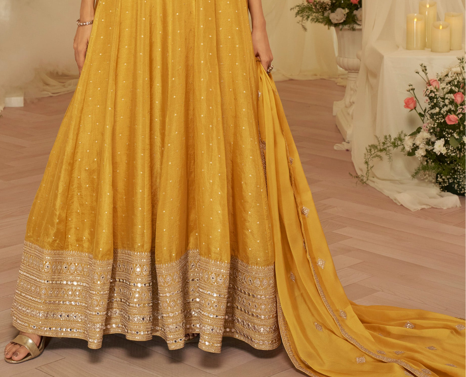 Three-quarter view of yellow anarkali with matching dupatta