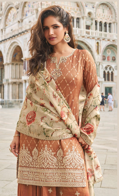 Close up of embroidery work on rust brown kameez