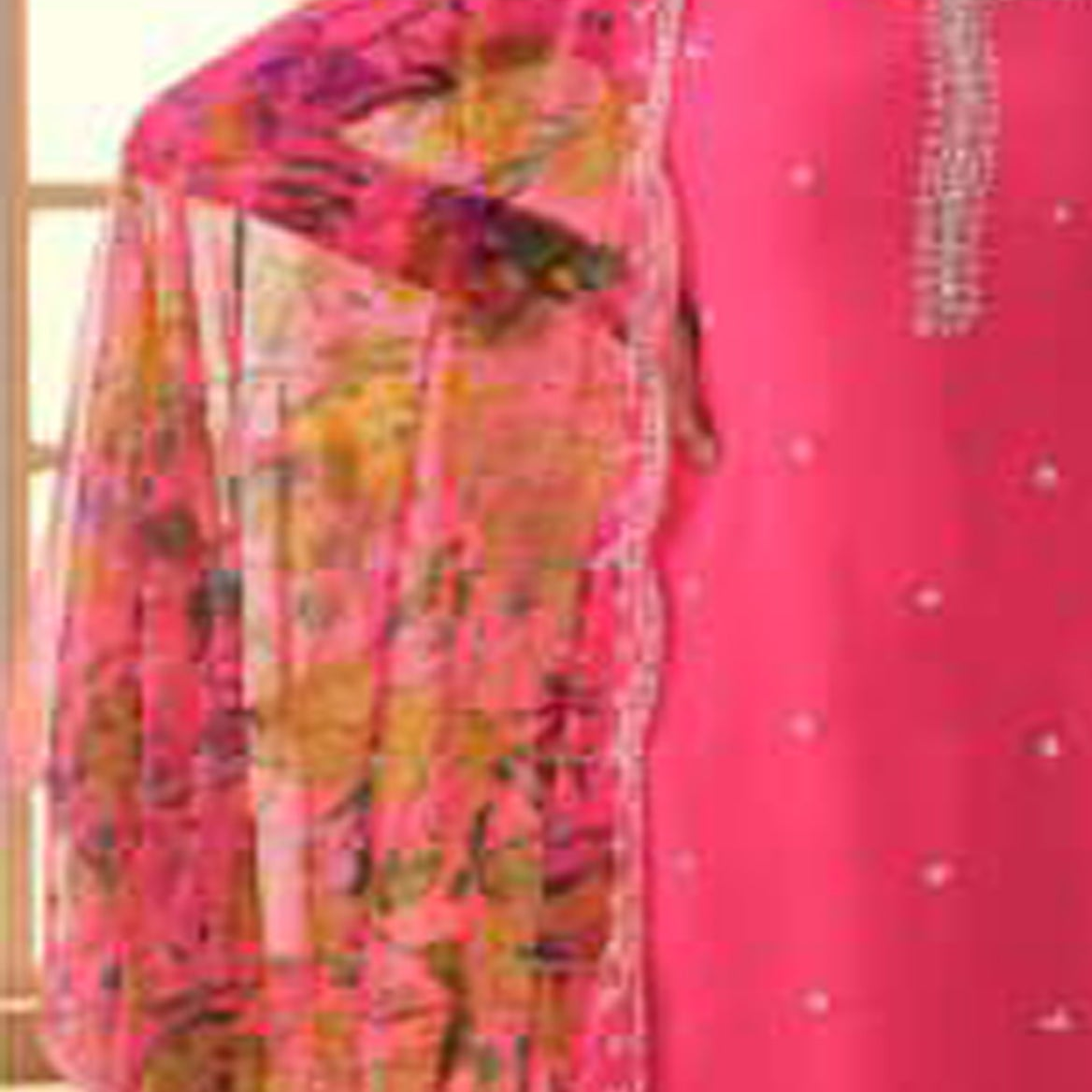 Close-up of heavy embroidery work on pink salwar kameez fabric