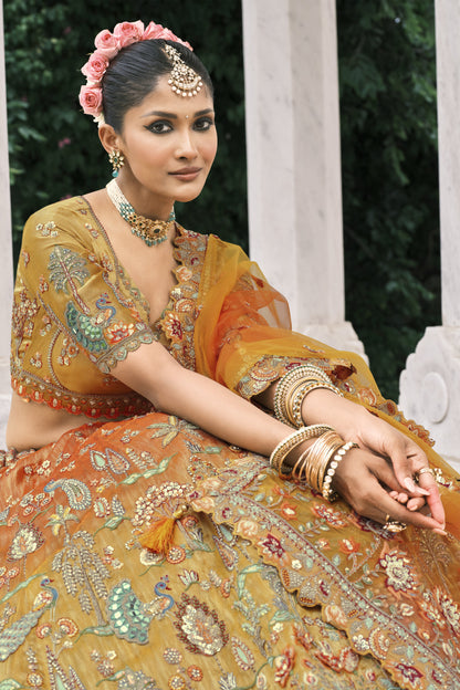 Close-up of zari and sequin work on orange lehenga