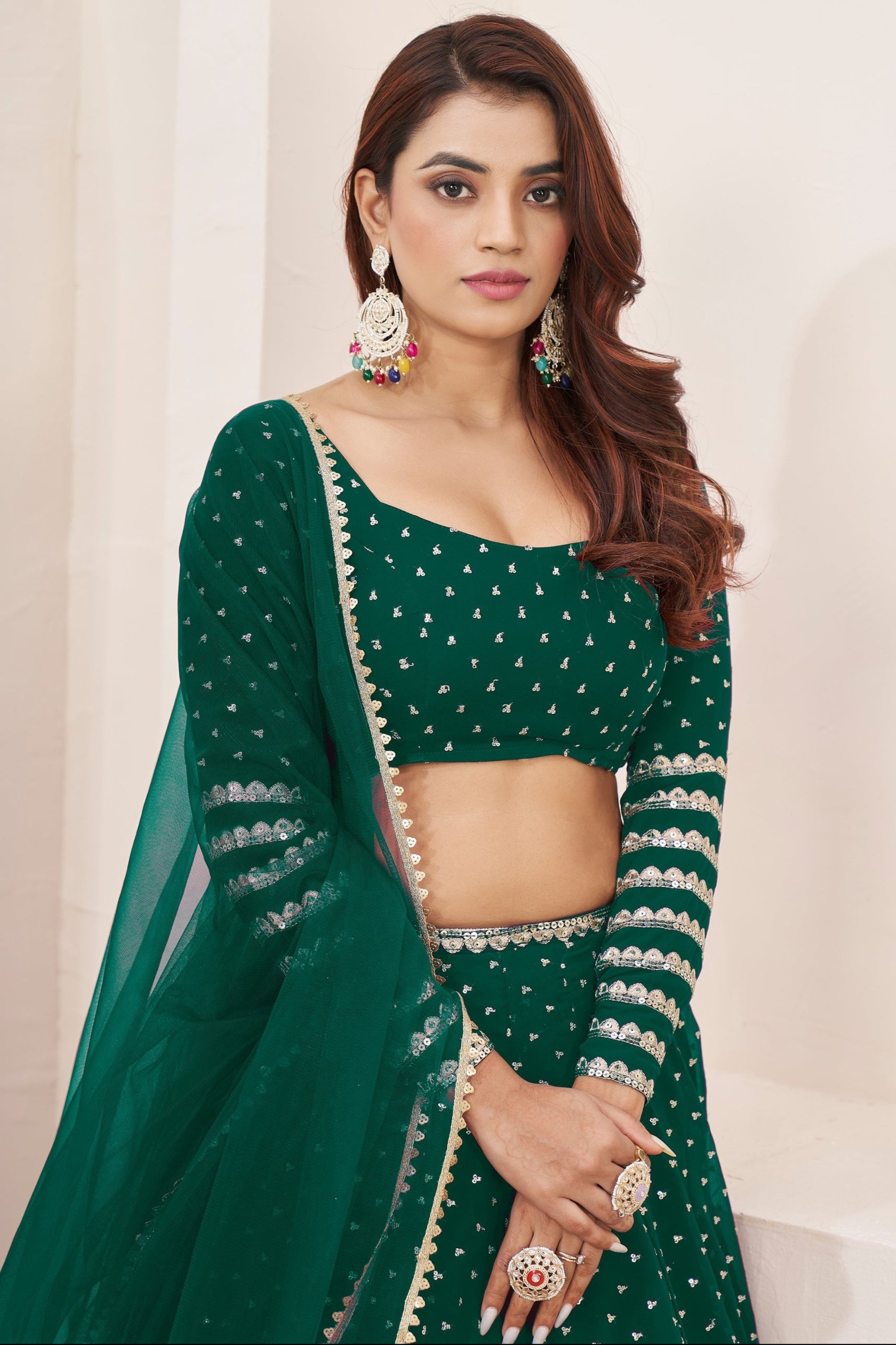 Thread embroidery close up on dark green choli blouse