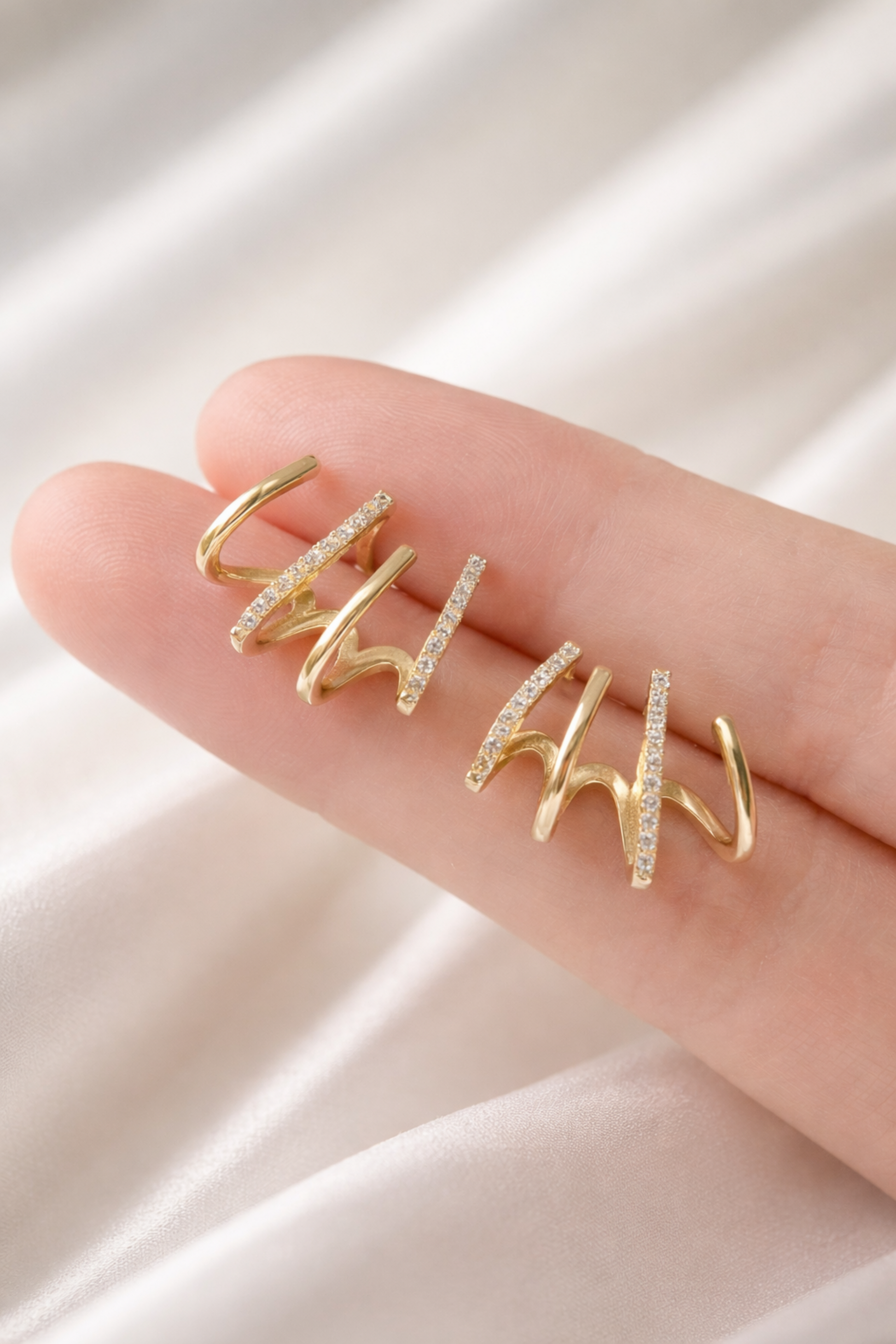 Minimal gold ear climber earrings with sparkling zircon stones close-up