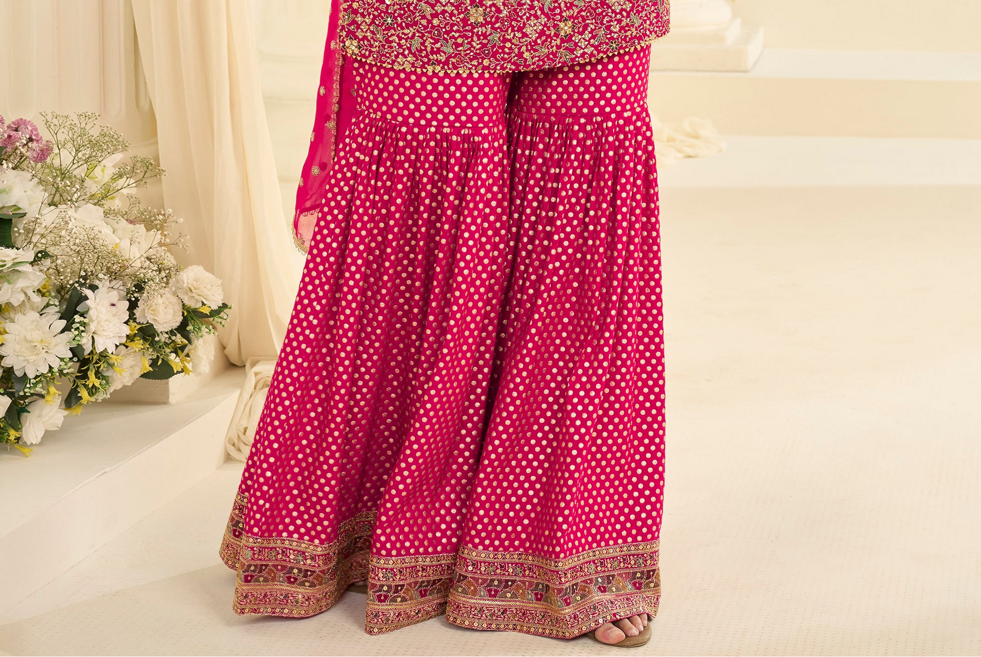 Model wearing pink sharara suit for wedding function