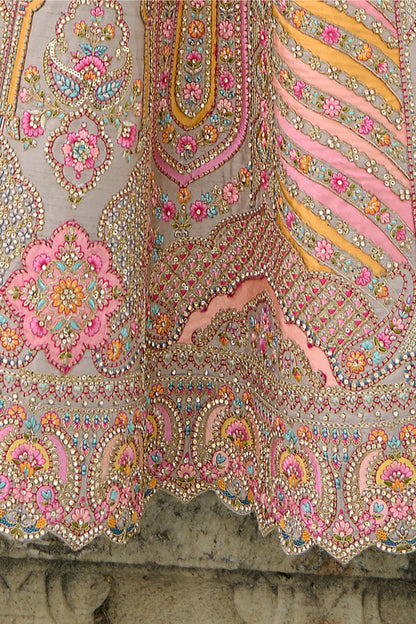 Embroidery craftsmanship on peach lehenga choli