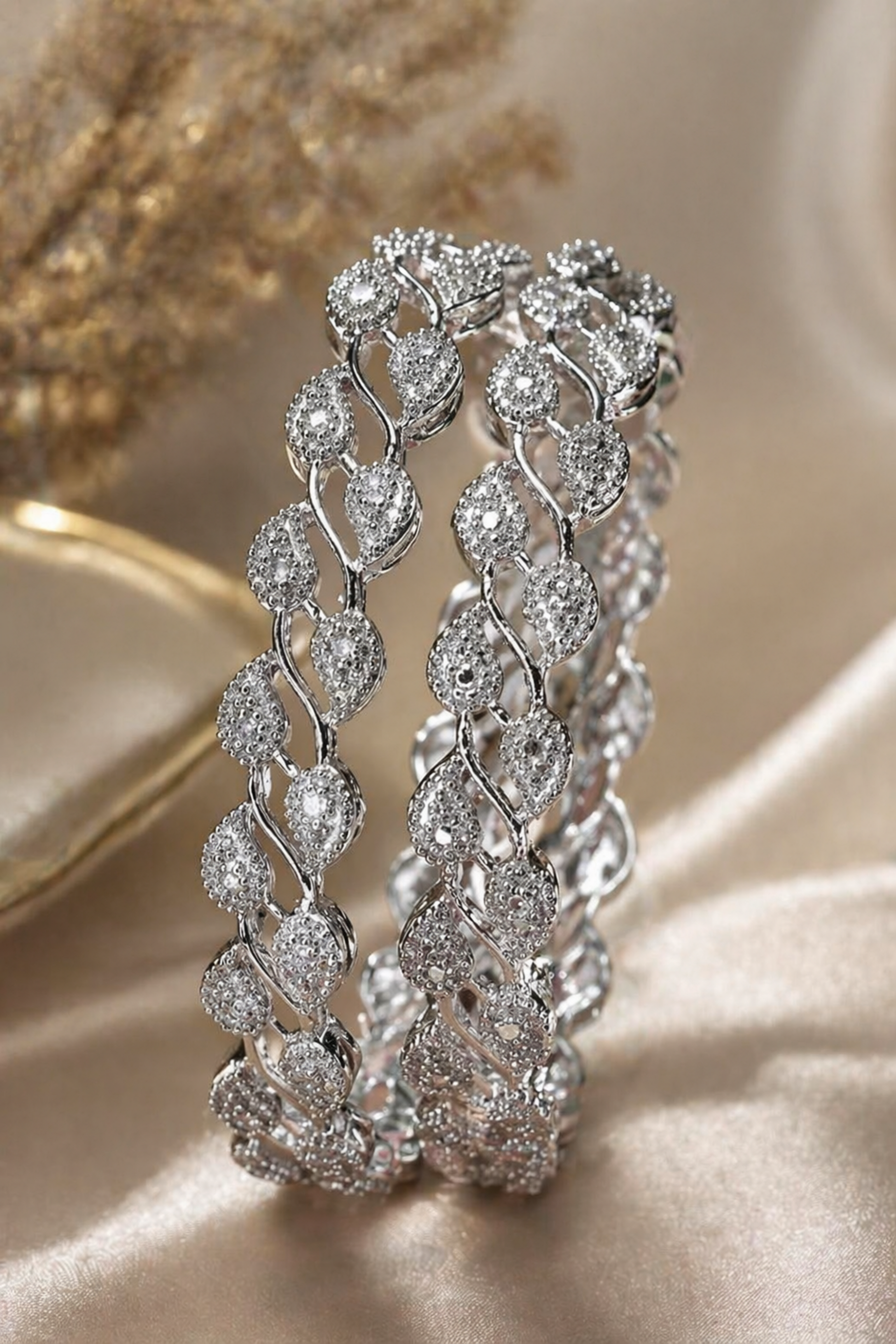 two bangles placed on soft fabric background