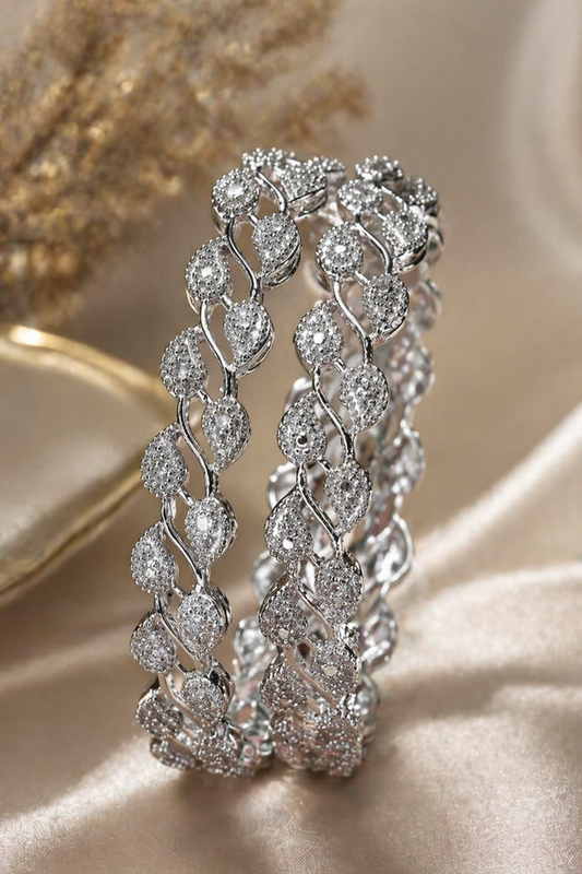two bangles placed on soft fabric background