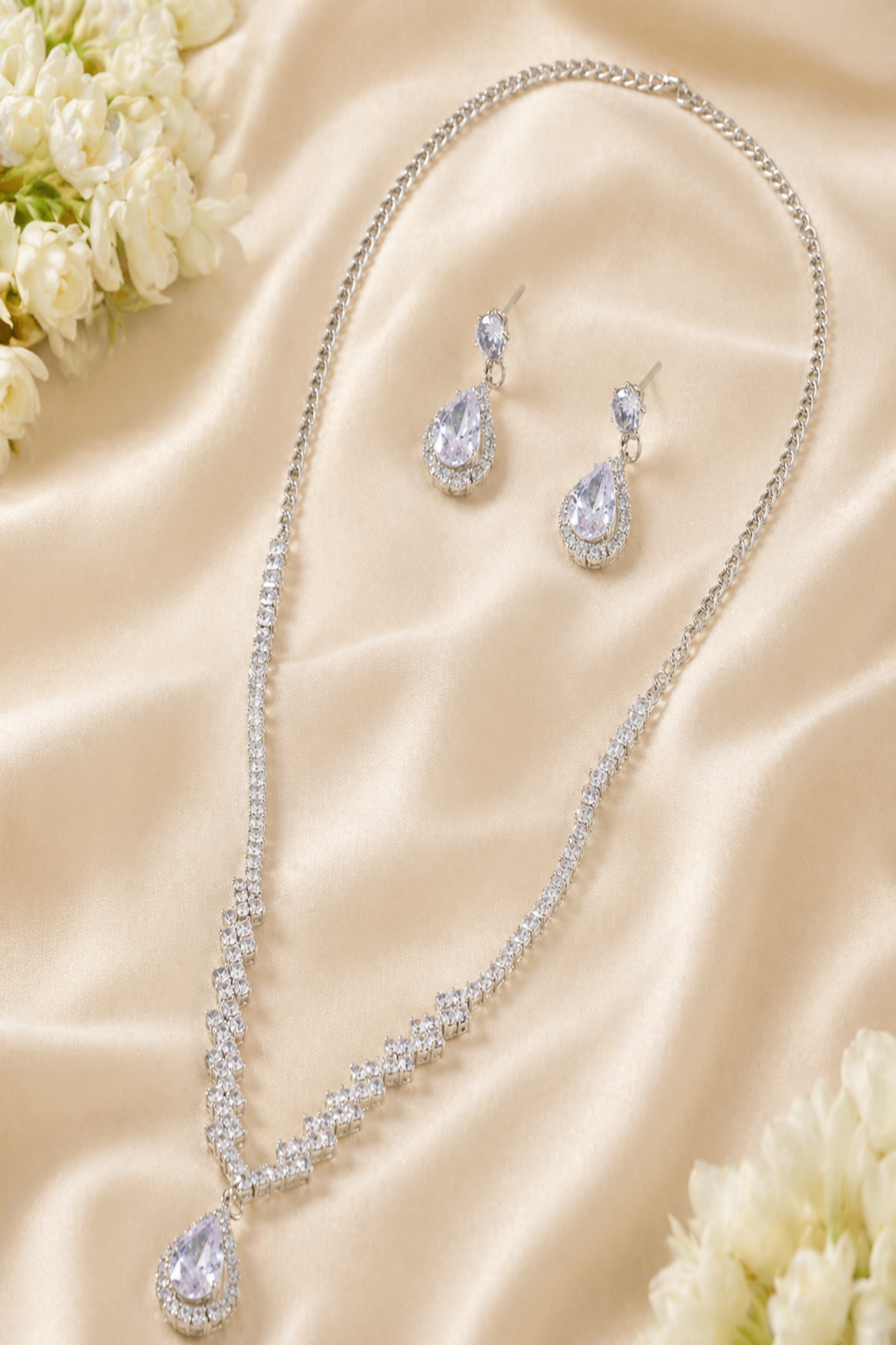 Jewelry set with necklace and earrings on a beige fabric background