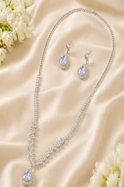 Jewelry set with necklace and earrings on a beige fabric background