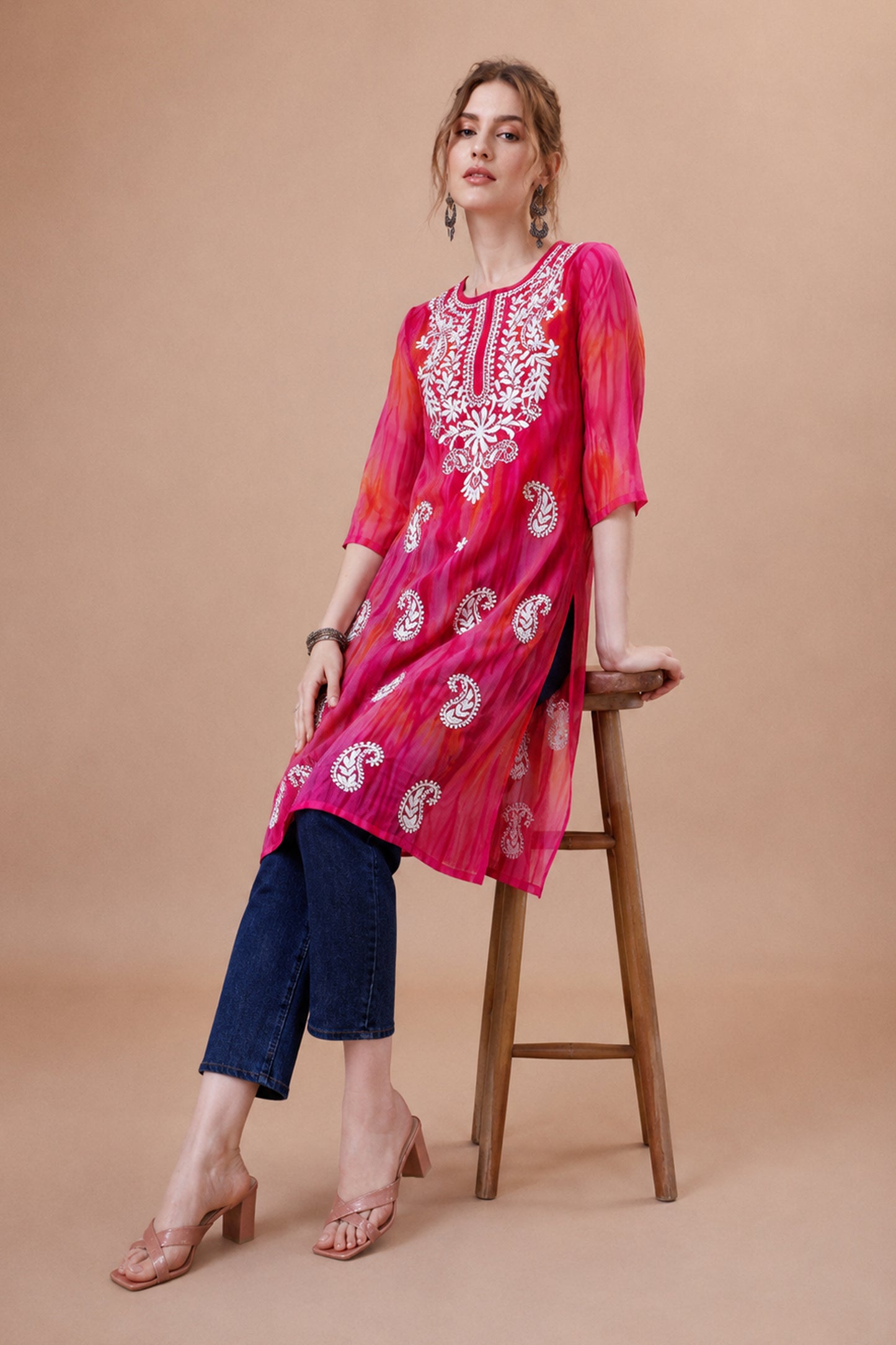 Woman wearing pink georgette kurti with paisley embroidered neckline