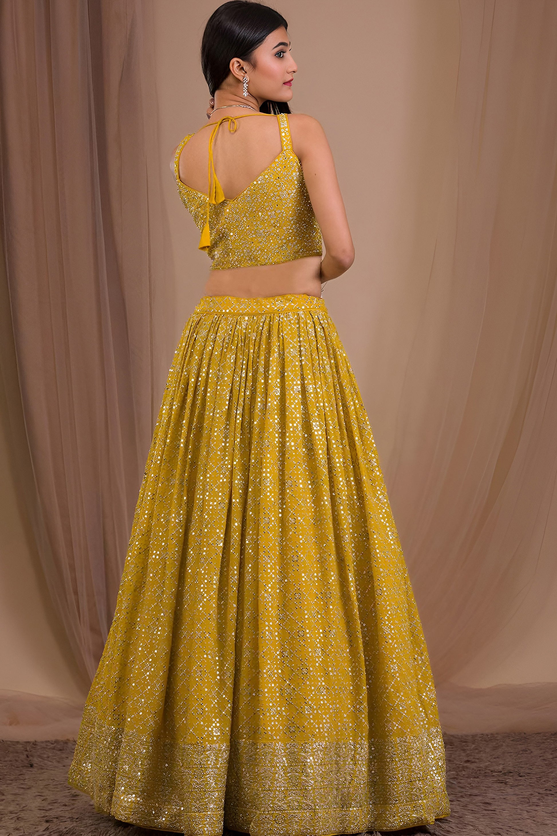 Sleeveless lehenga choli in dark yellow georgette fabric