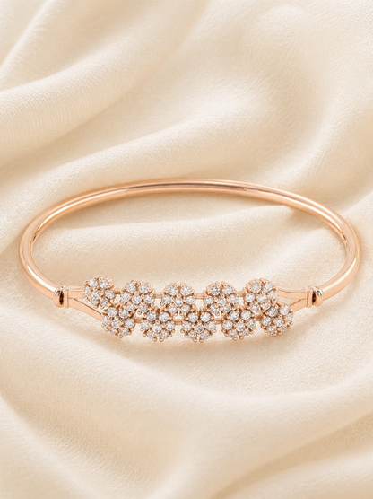 slim metal bracelet with central flower design