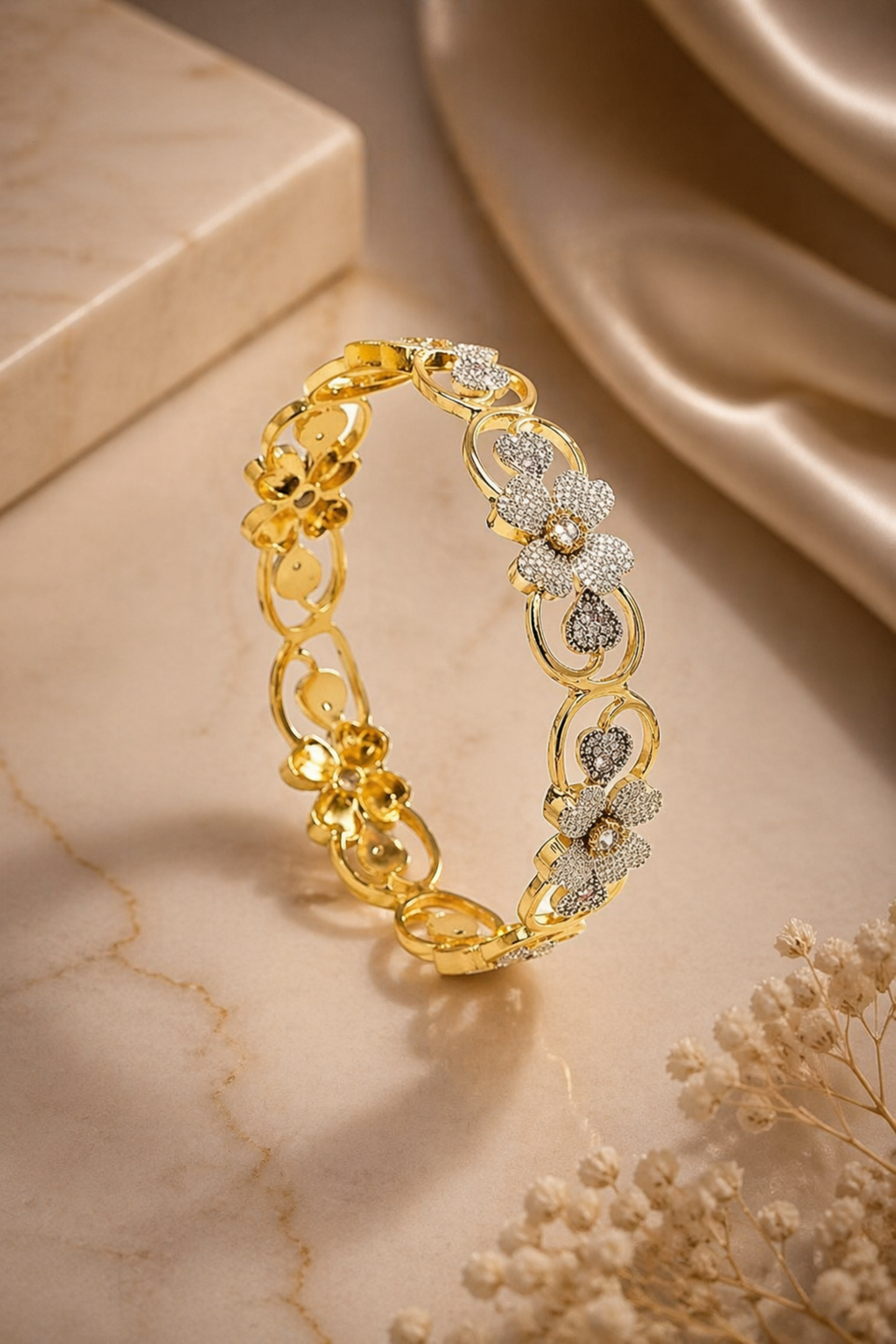 gold-tone bracelet standing upright with soft fabric background