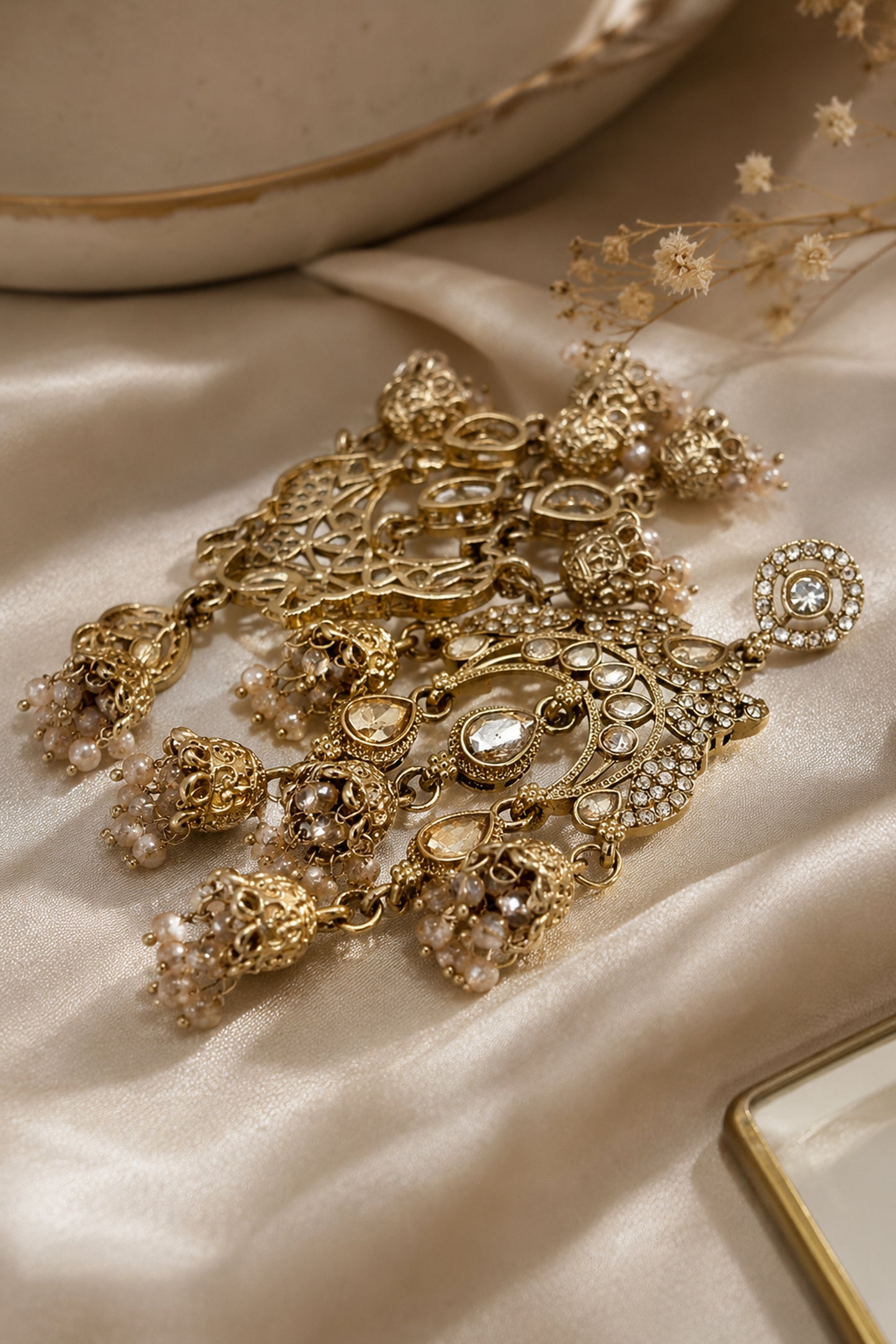 Side angle of statement ethnic drop earrings