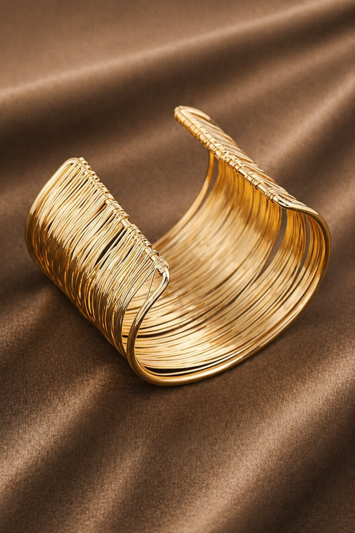 close-up of layered gold tone cuff bracelet surface