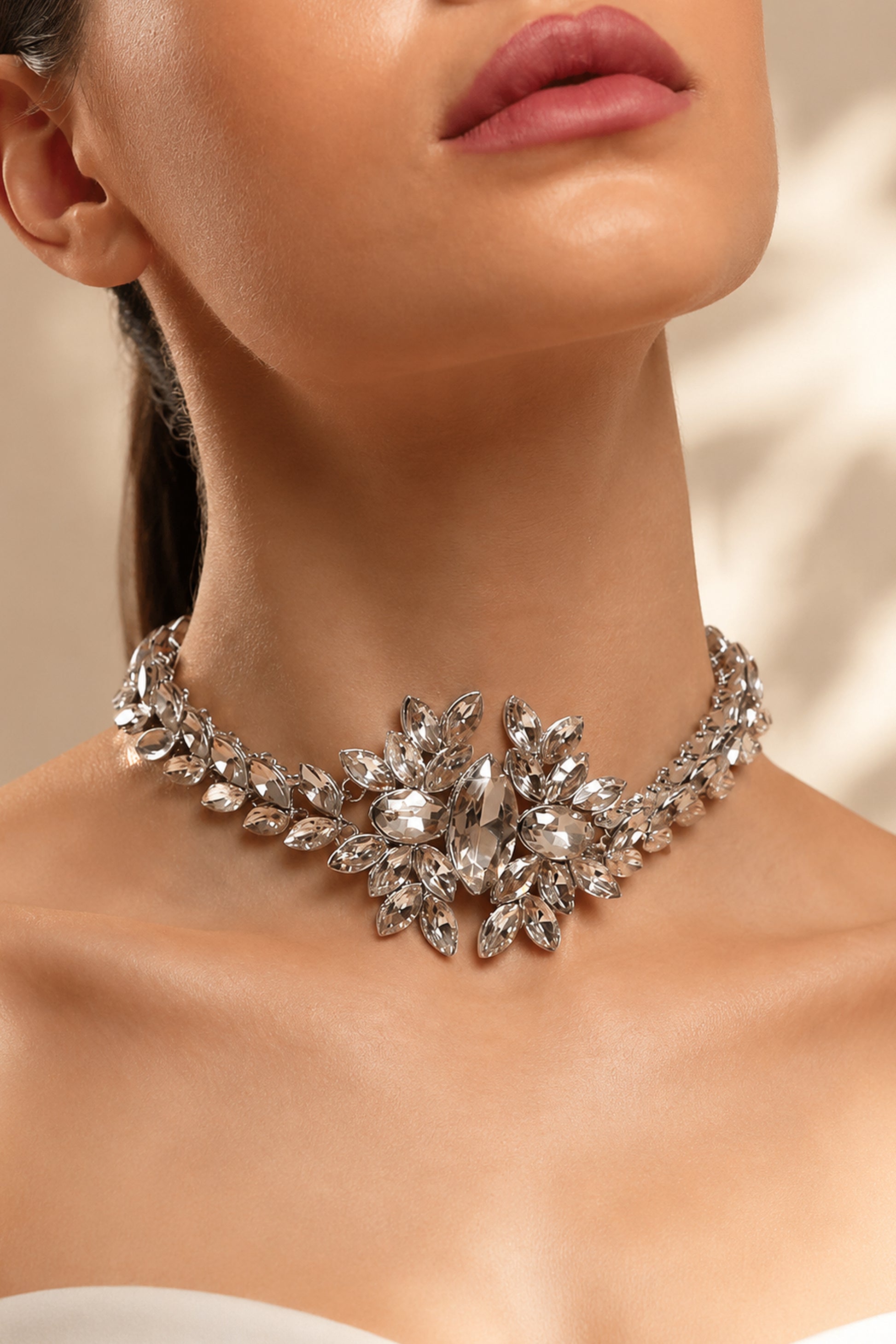 Statement necklace arranged on soft luxury backdrop