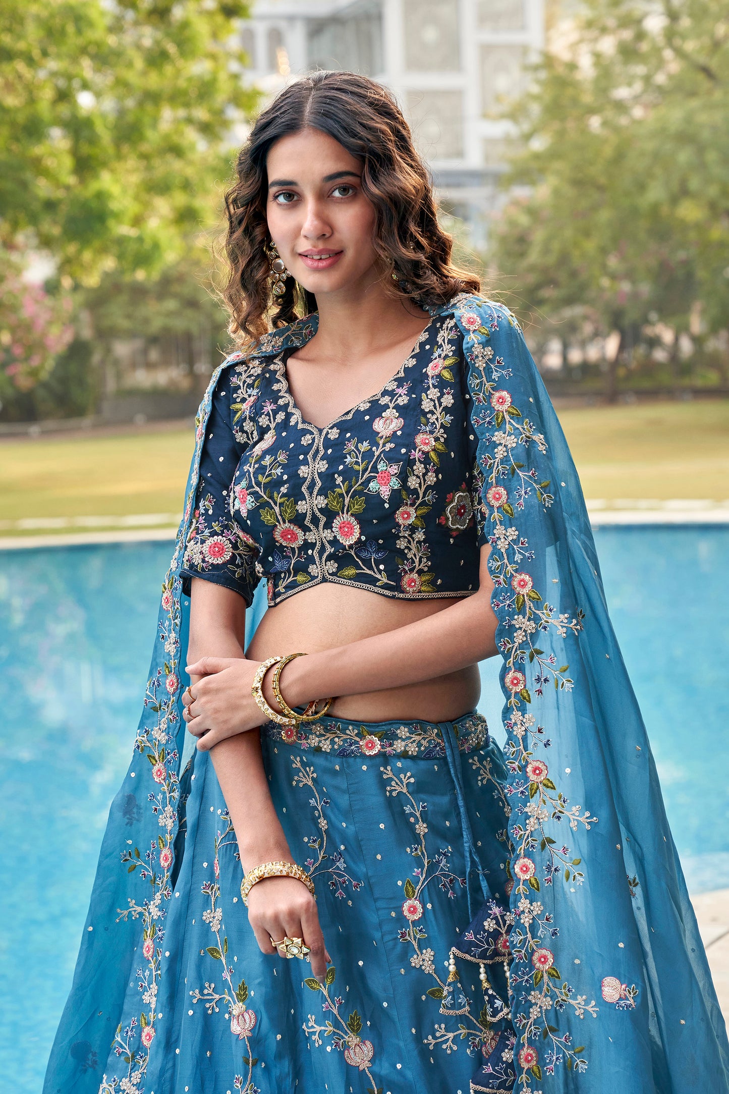 Close-up of sequins and zari work on blue lehenga