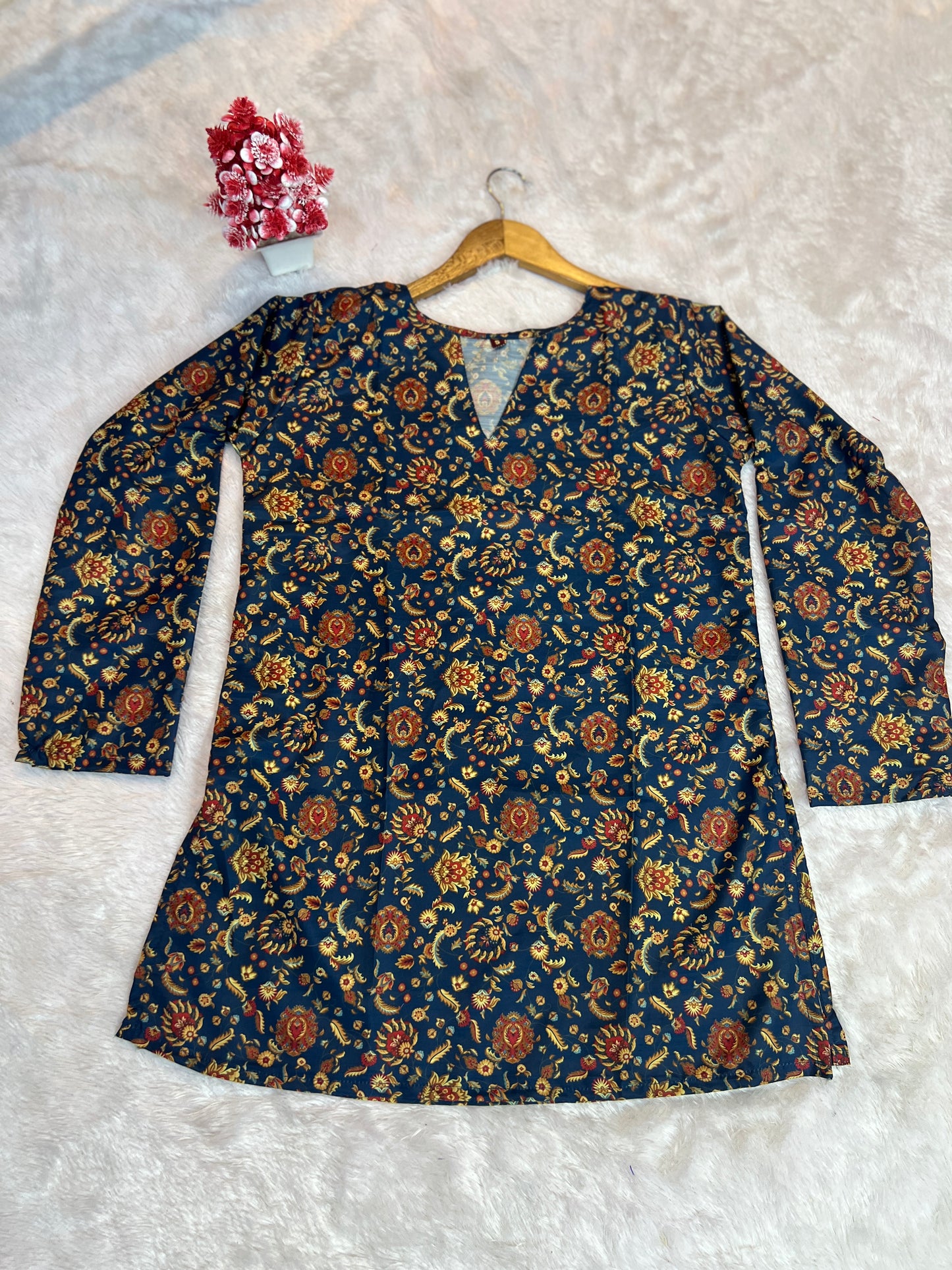 detail of neckline and print placement on silk top