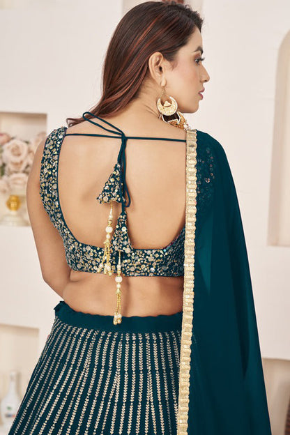 Back design of teal blue choli with embroidery detail