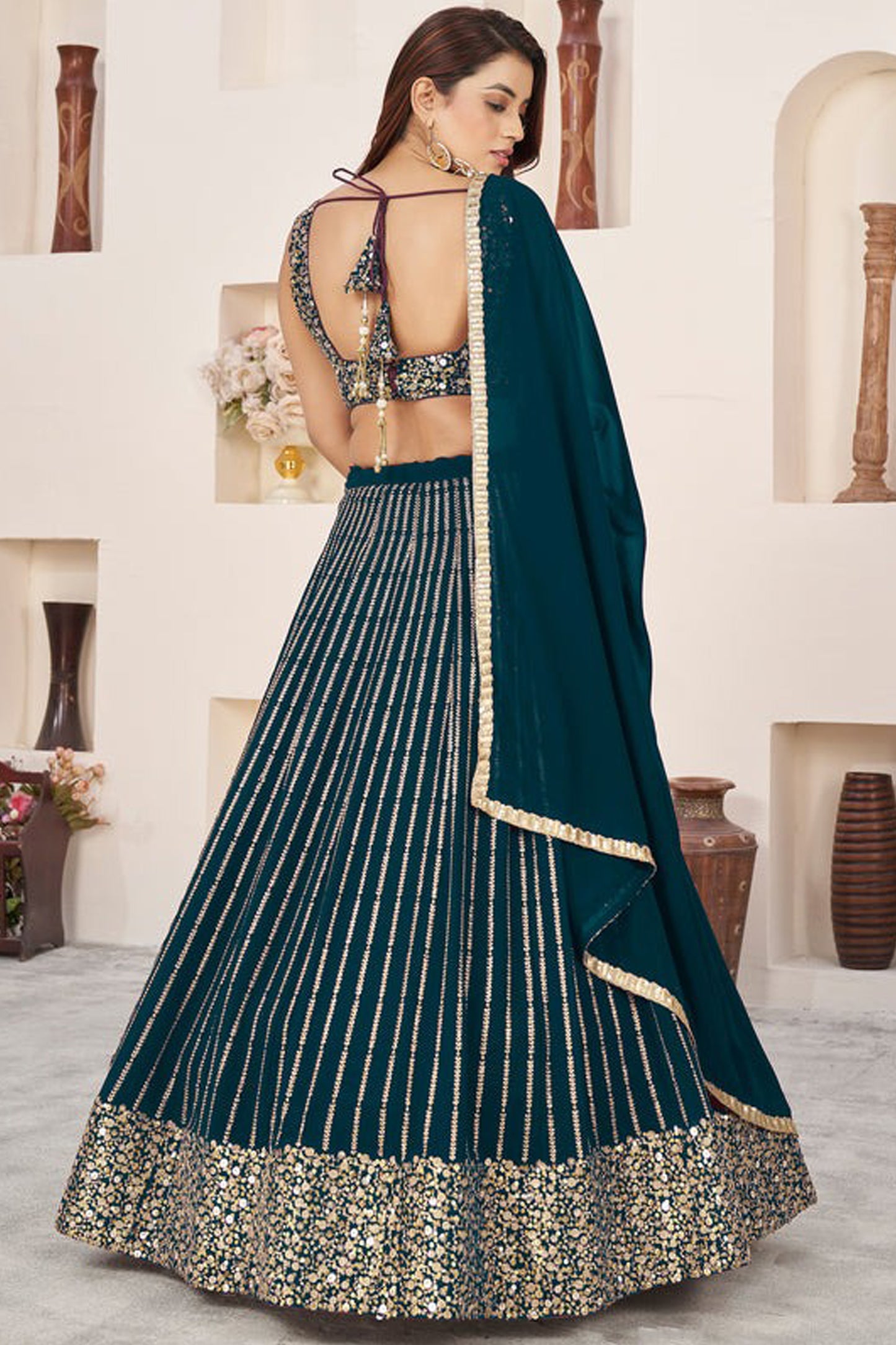 Side angle of teal blue lehenga choli with flowing silhouette