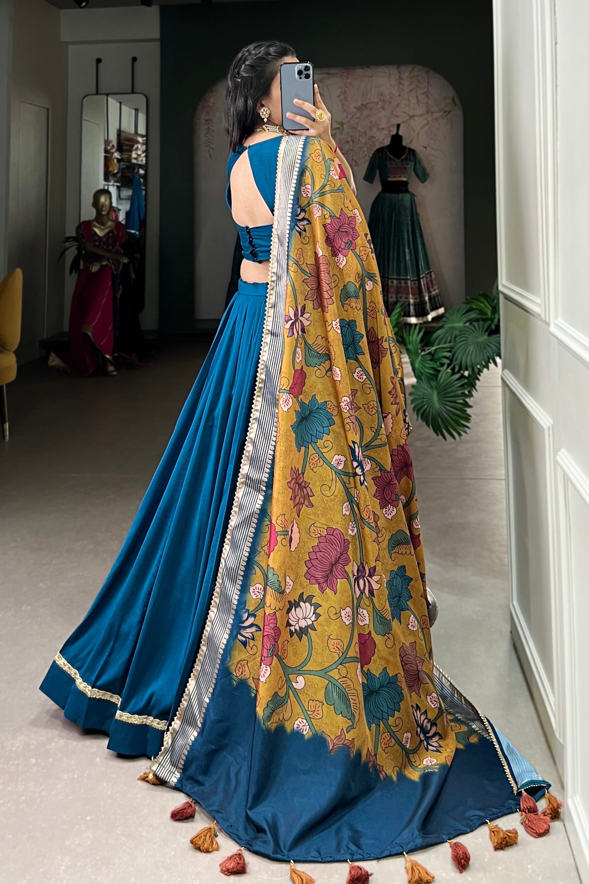 back view of teal blue lehenga choli with printed design
