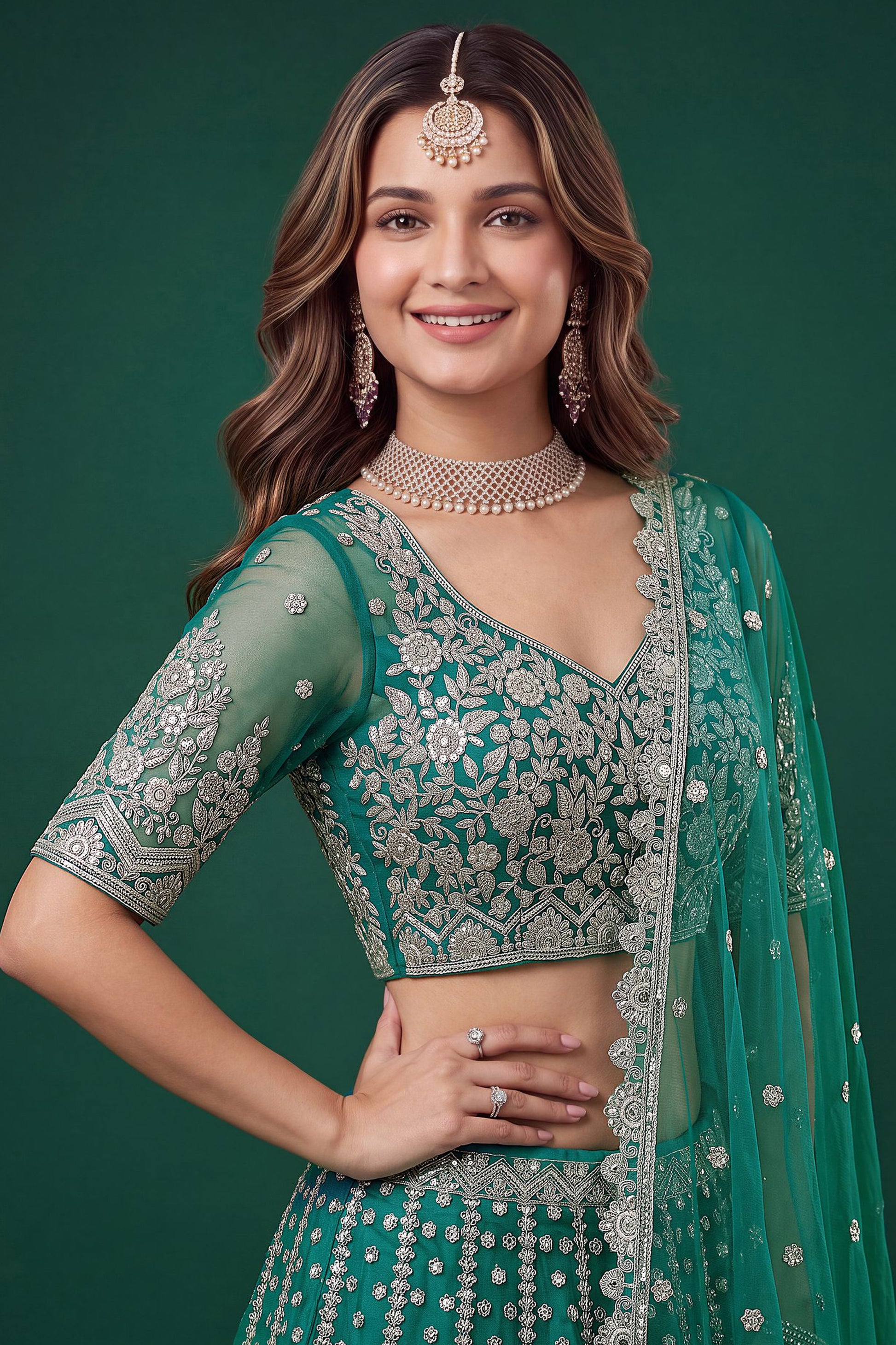 Front view of teal blue lehenga choli with embroidered detailing