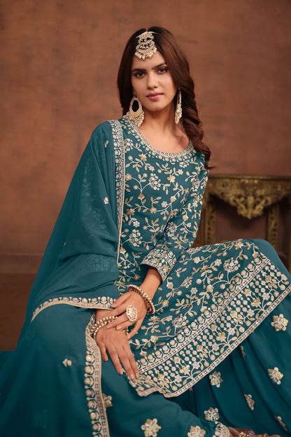 Detail of dupatta draped over shoulder in teal blue fabric