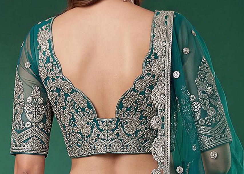 Back view of teal blue lehenga choli with embroidered detailing