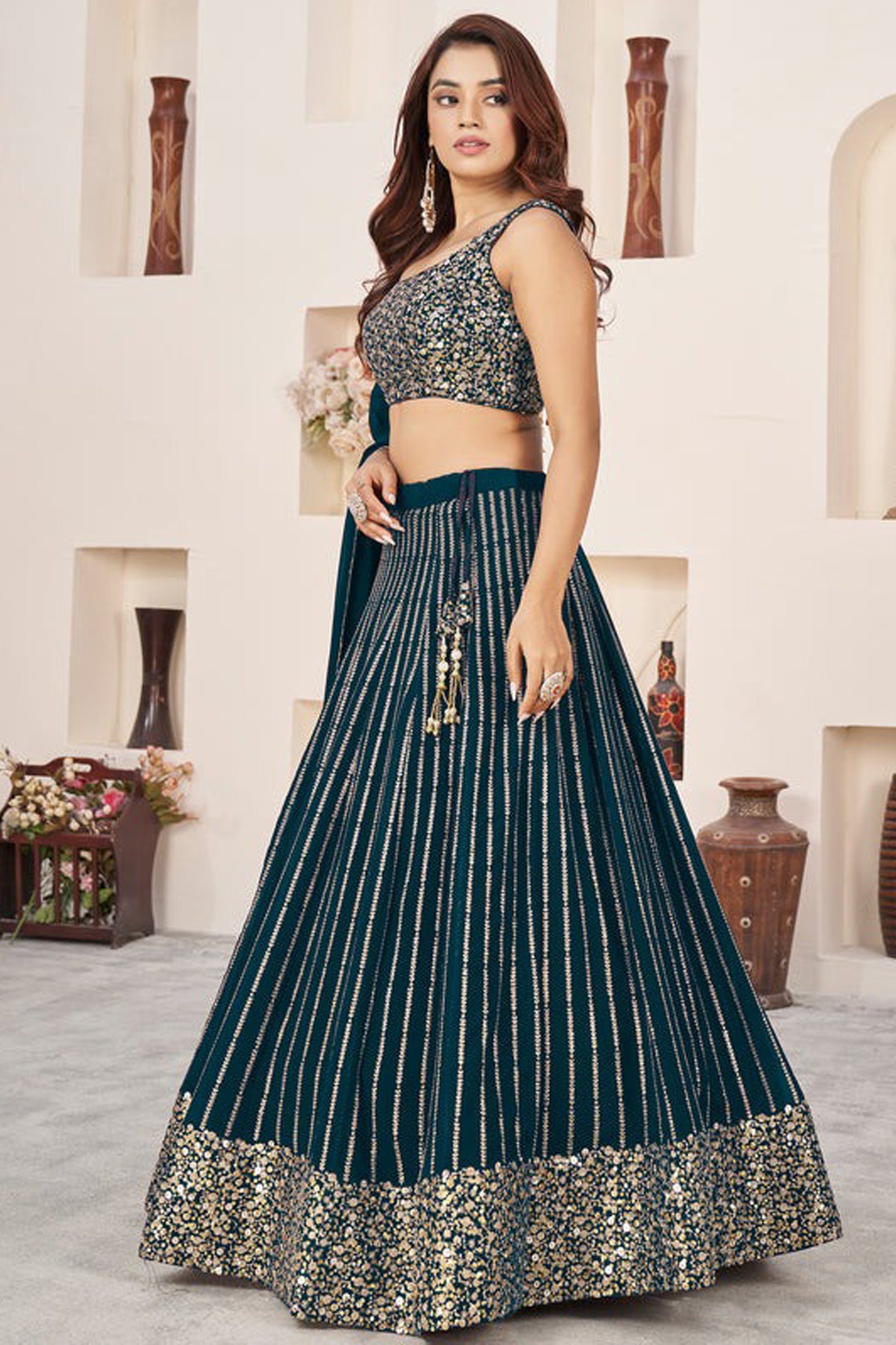Detailed border work on teal blue lehenga skirt