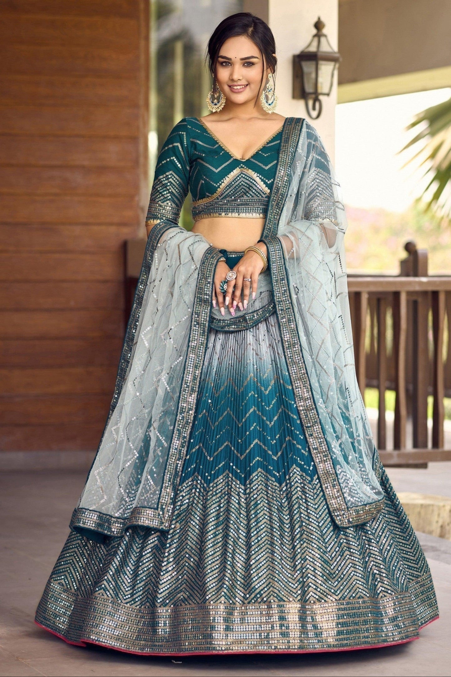 Teal lehenga designs for wedding front view with embroidery