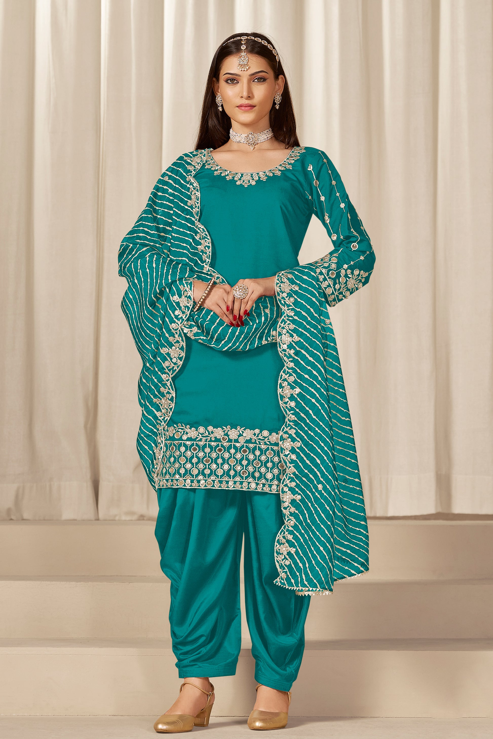 Front view of teal blue patiala with embroidery and mirror work