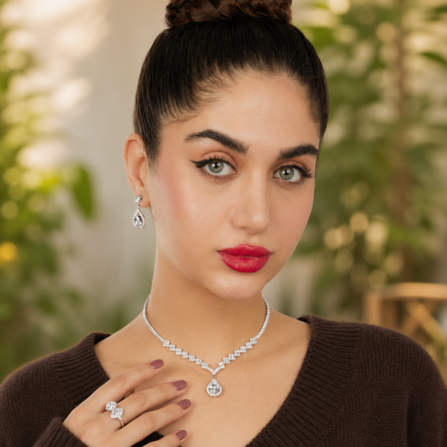 Model wearing teardrop necklace set with matching earrings