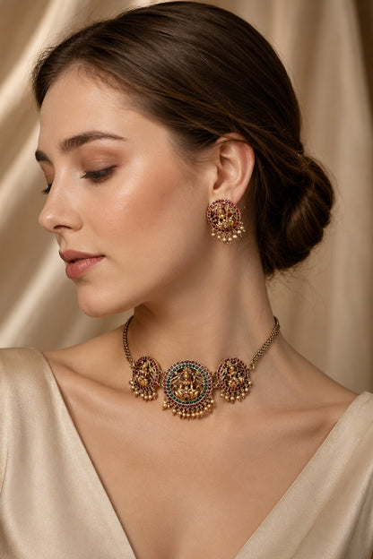 Temple jewelry set with sculpted circular motifs, red and green stones and pearl-like drops