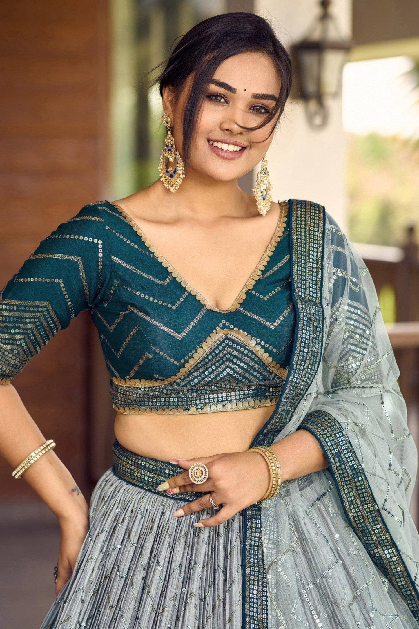 Close-up of sequins and thread embroidery on teal chinon lehenga