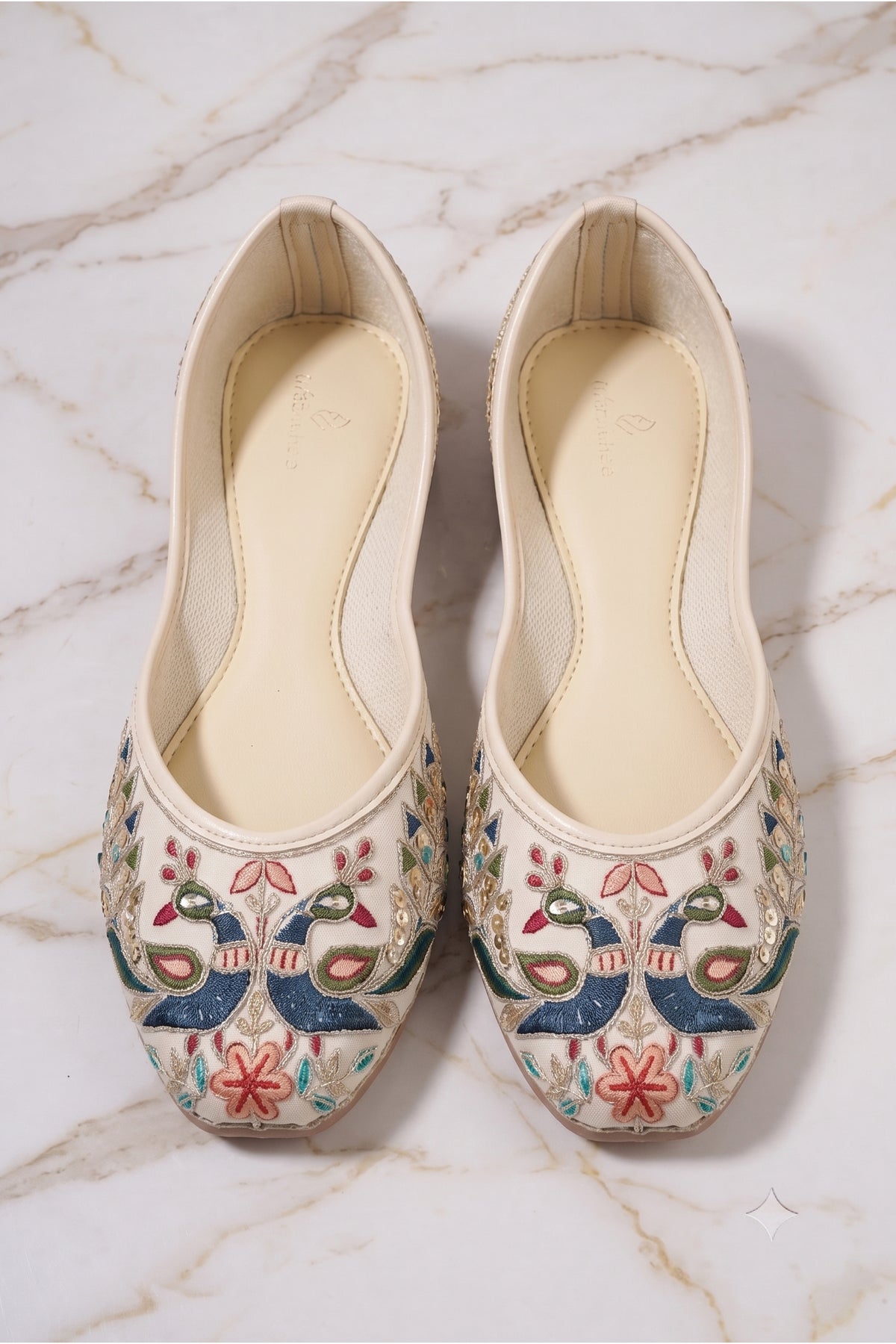 Detailed view of metallic gold sequins and colorful threadwork on festive jutti