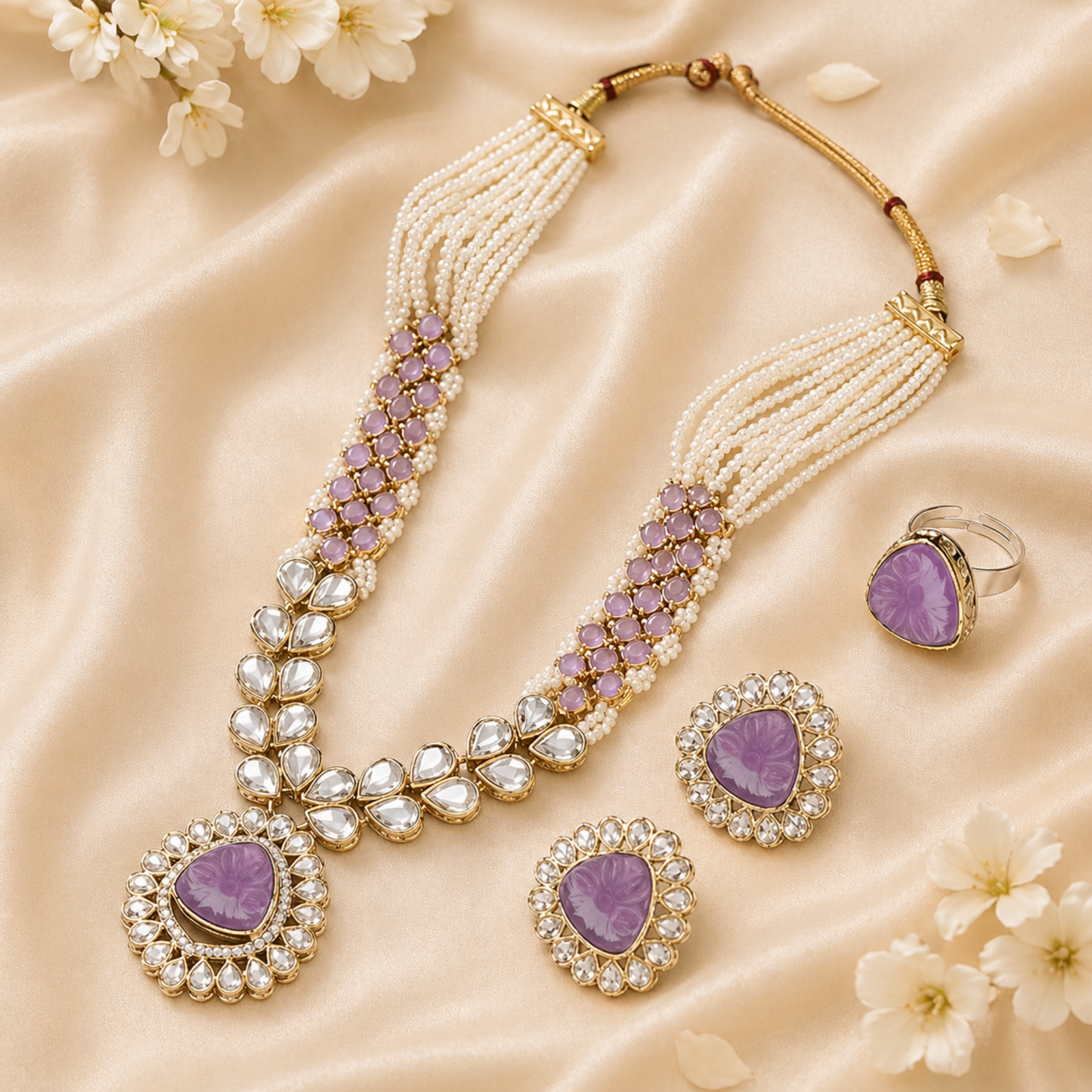 Traditional purple kundan necklace set laid on satin fabric