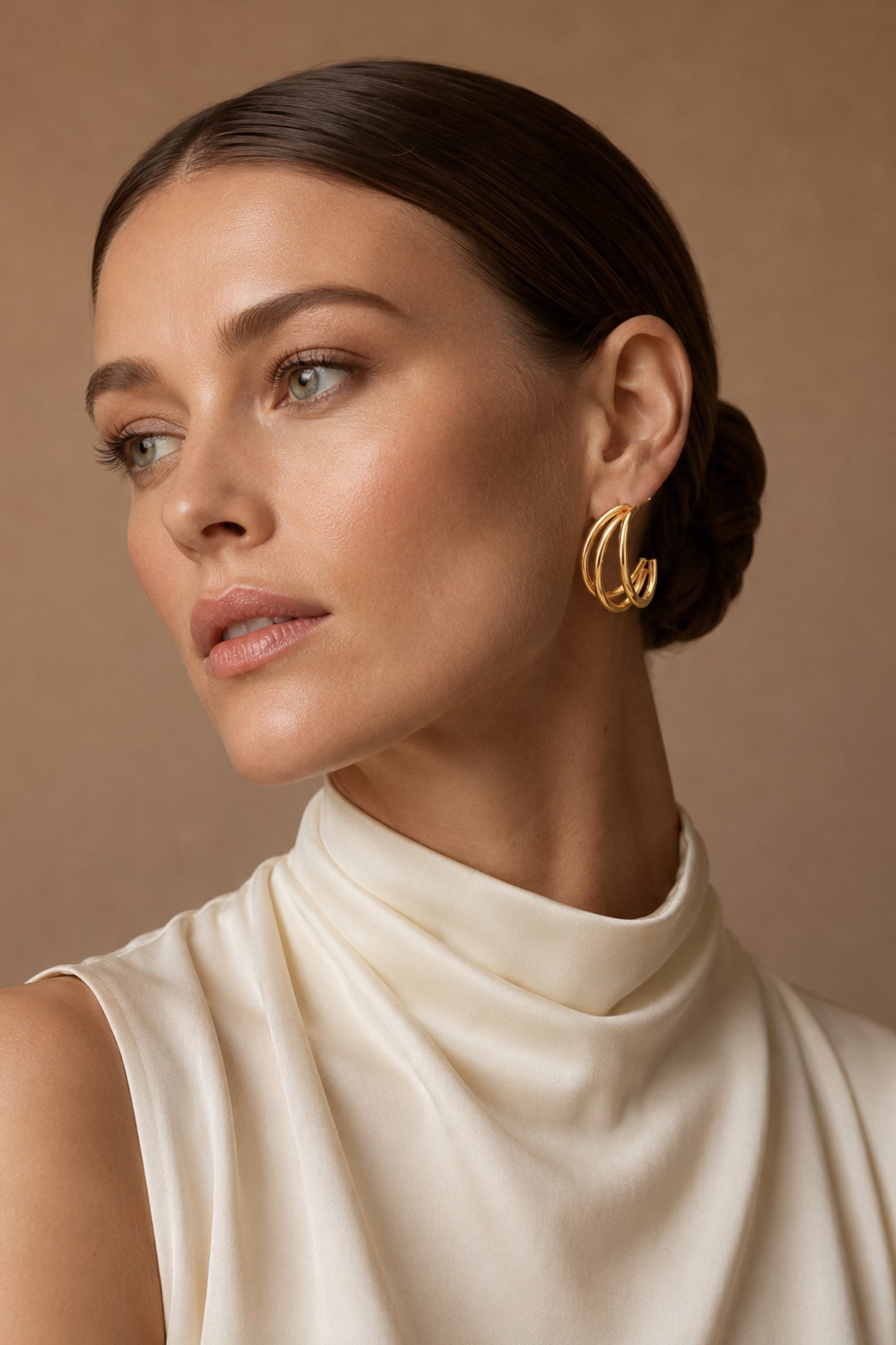 Layered triple-loop gold-tone hoop styled with an ivory top