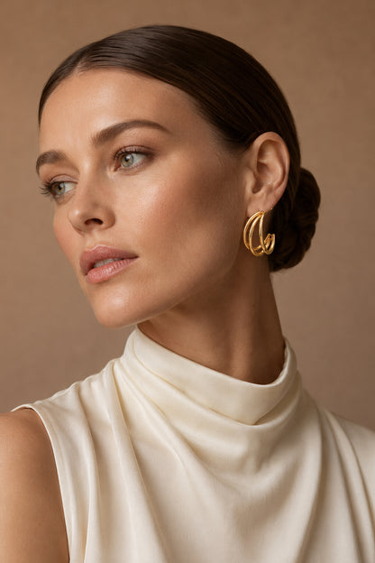 Layered triple-loop gold-tone hoop styled with an ivory top