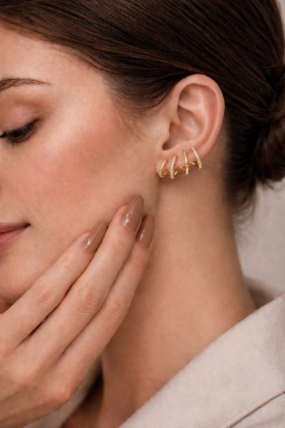 Woman wearing gold ear climber earrings with crystal detail elegant look