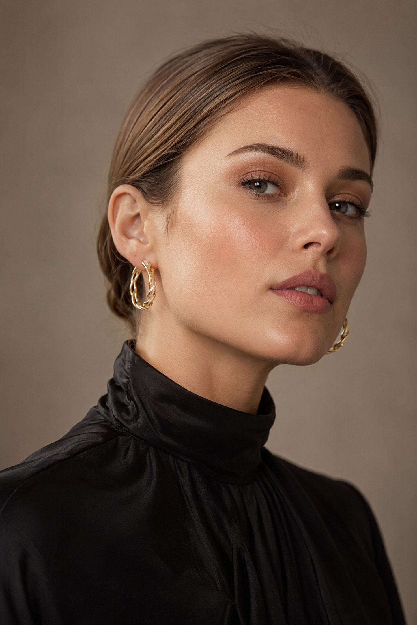 European model wearing gold-tone pearl-accented hoop earrings