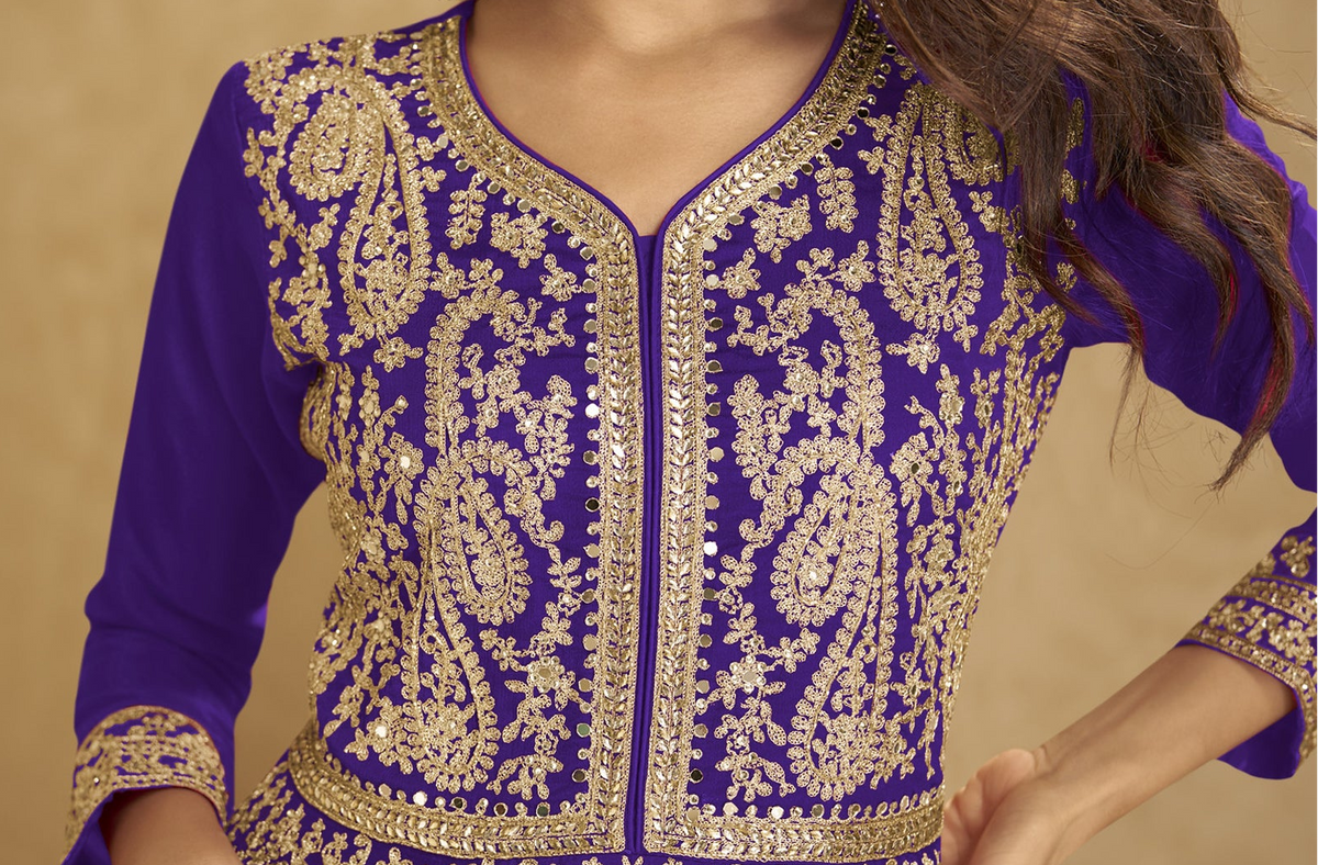 Close-up of mirror work on purple embroidered top