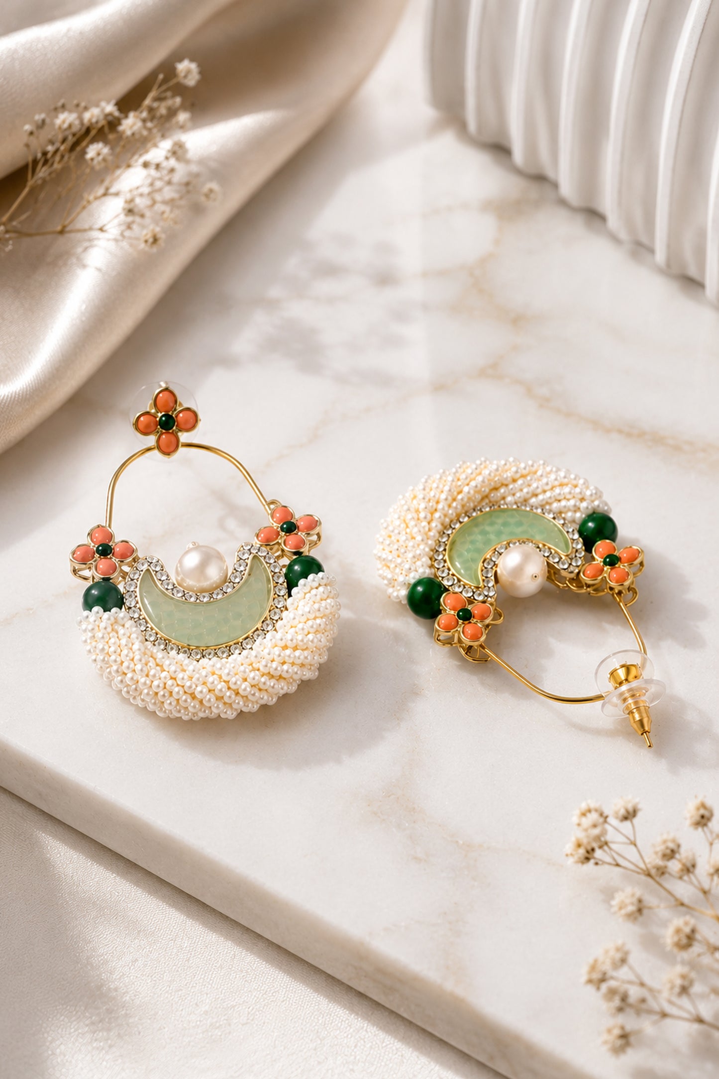 White hoop earrings with layered seed beads and floral accents