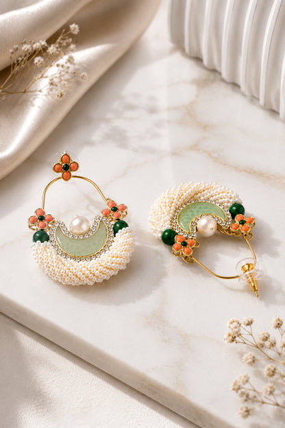 White hoop earrings with layered seed beads and floral accents