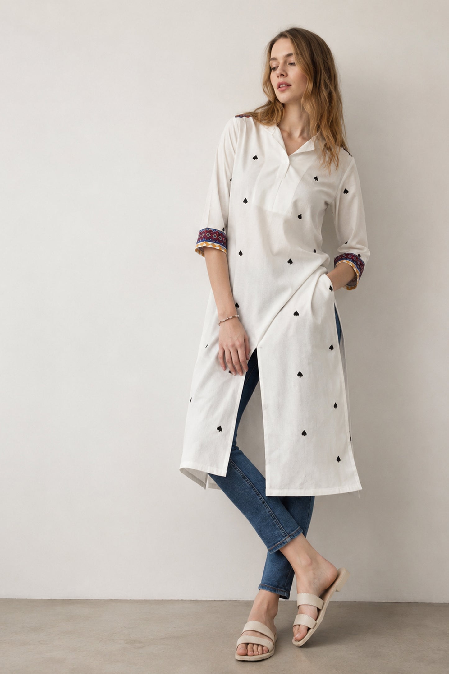 Woman wearing white kurti with geometric printed detail