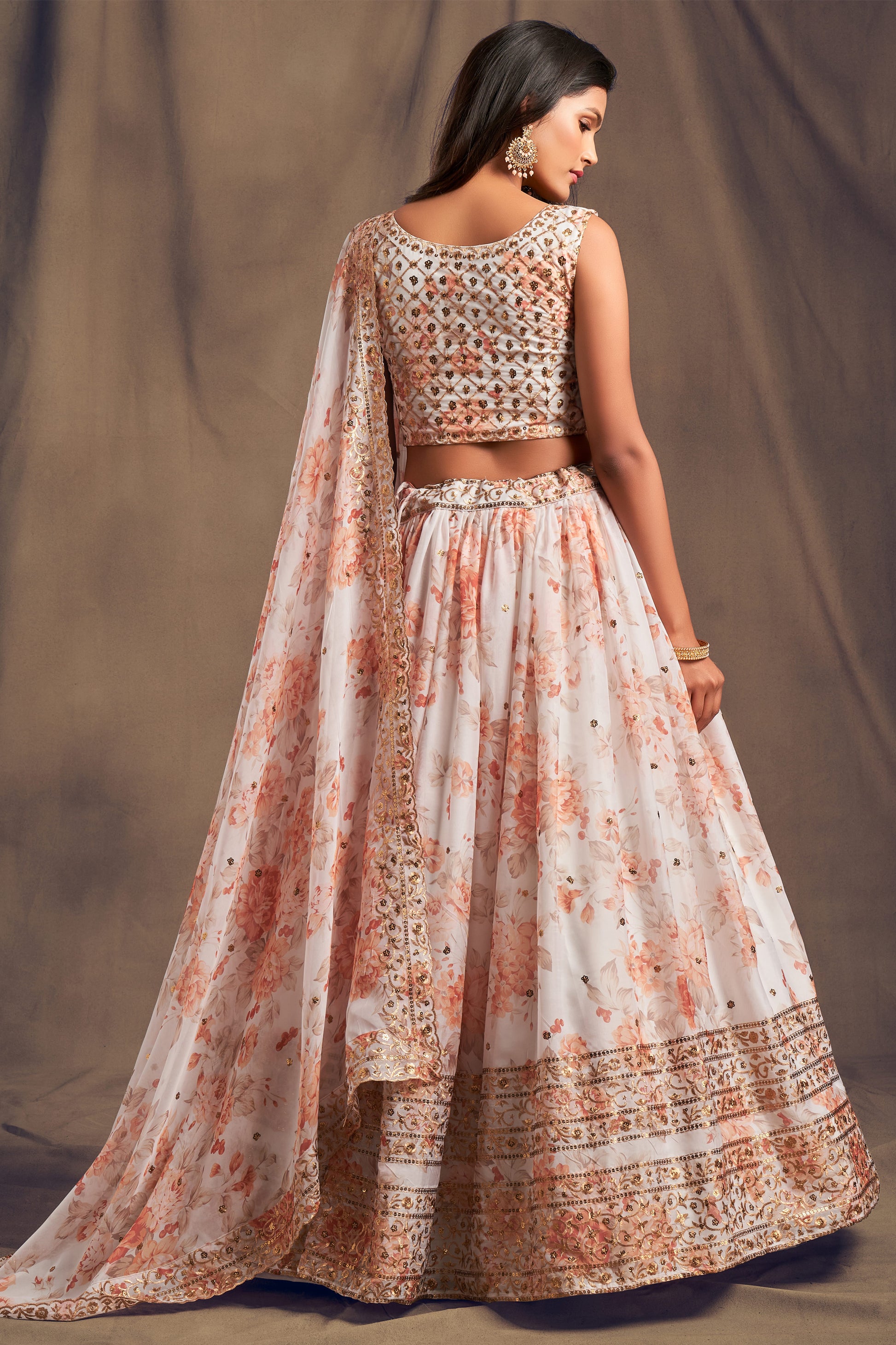 Back view of white lehenga with detailed choli design