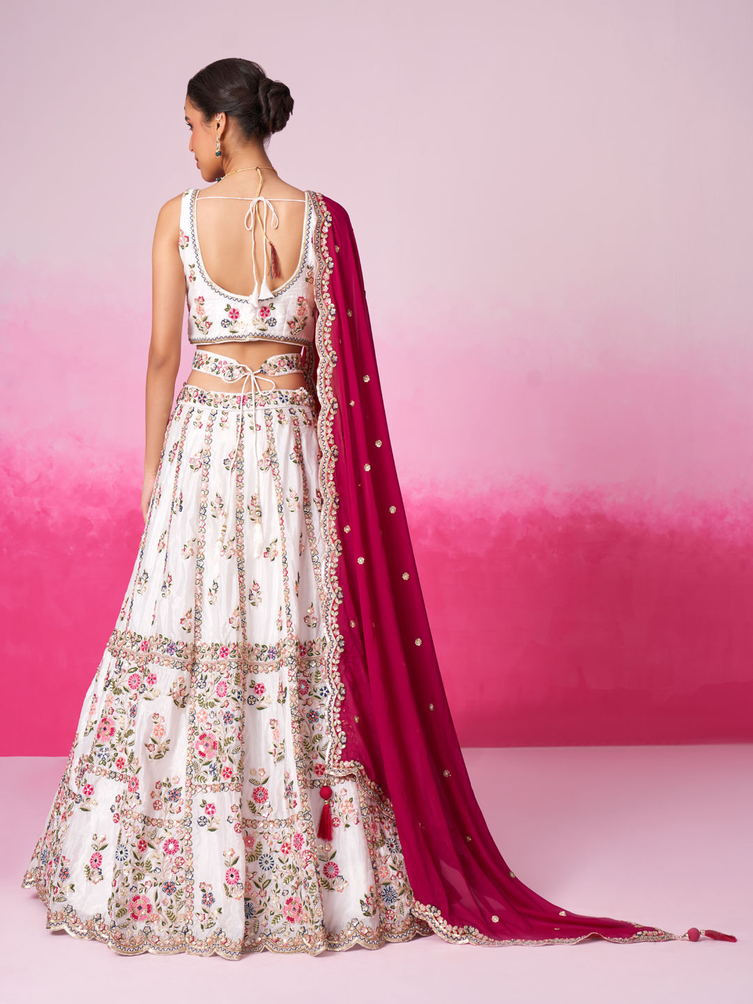 Back view of white indian bridal outfit with embroidery