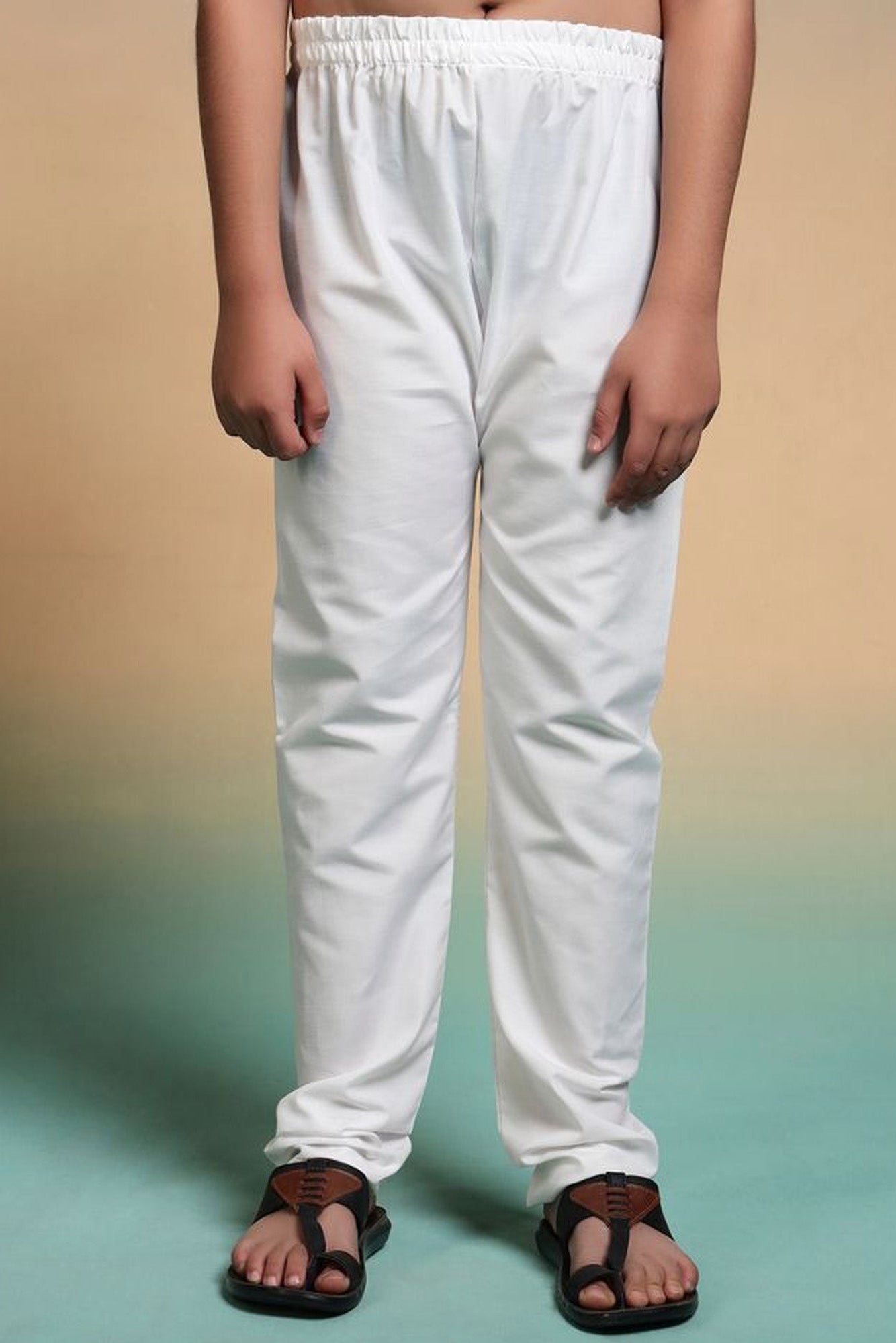 White pants worn by a person on a gradient background