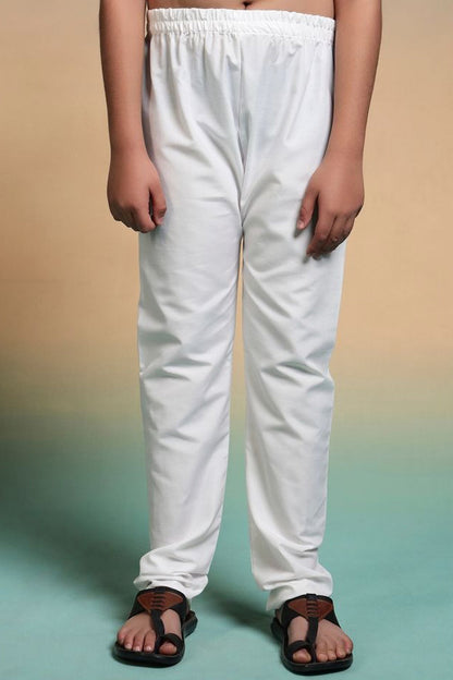 White pants worn by a person on a gradient background