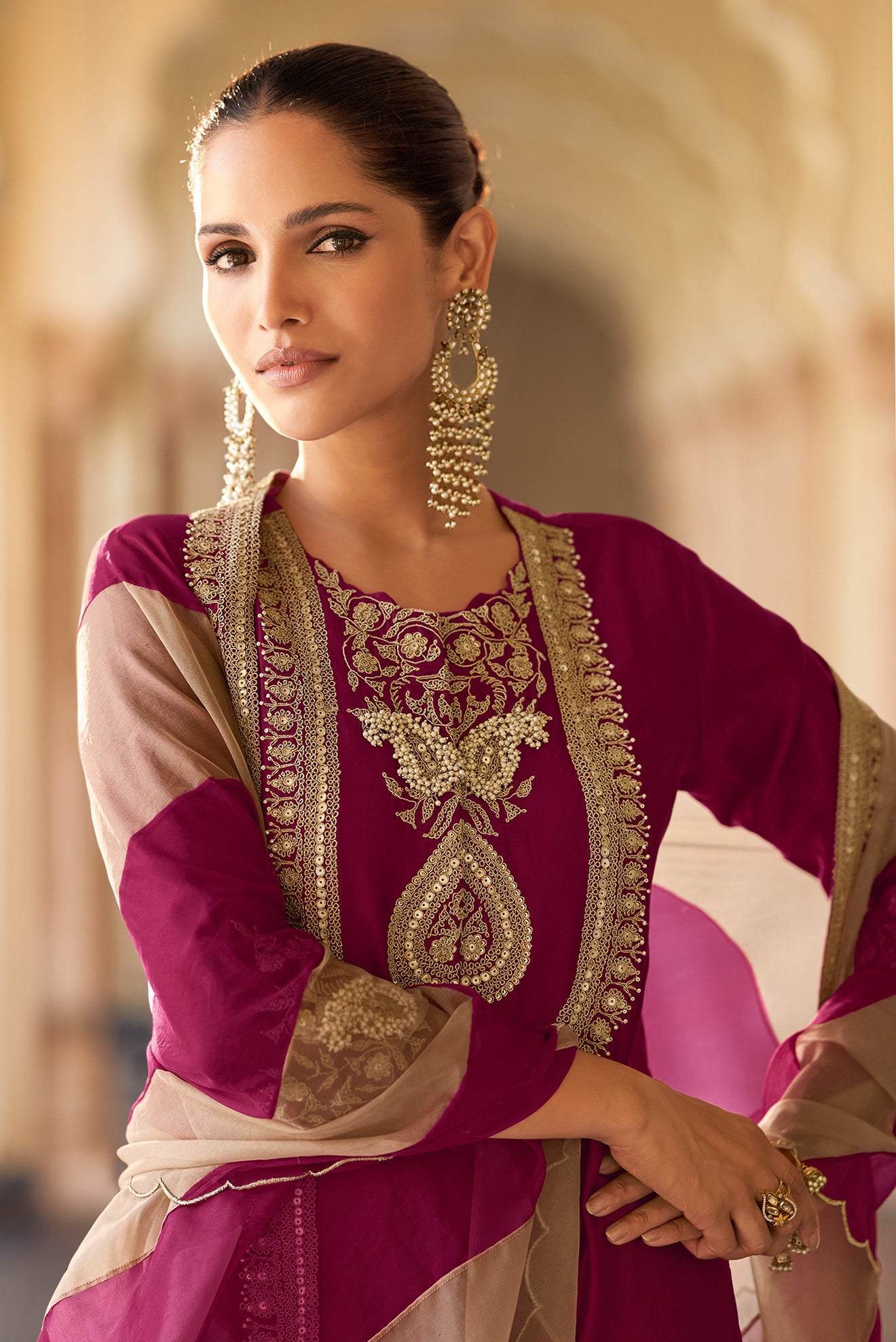 Close up of embroidery work on wine kameez